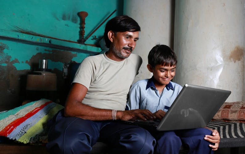 a father and son on a computer